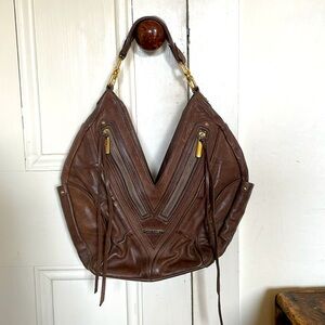 Jack Rabbit brown leather hobo bag with zipper and fringe detail.